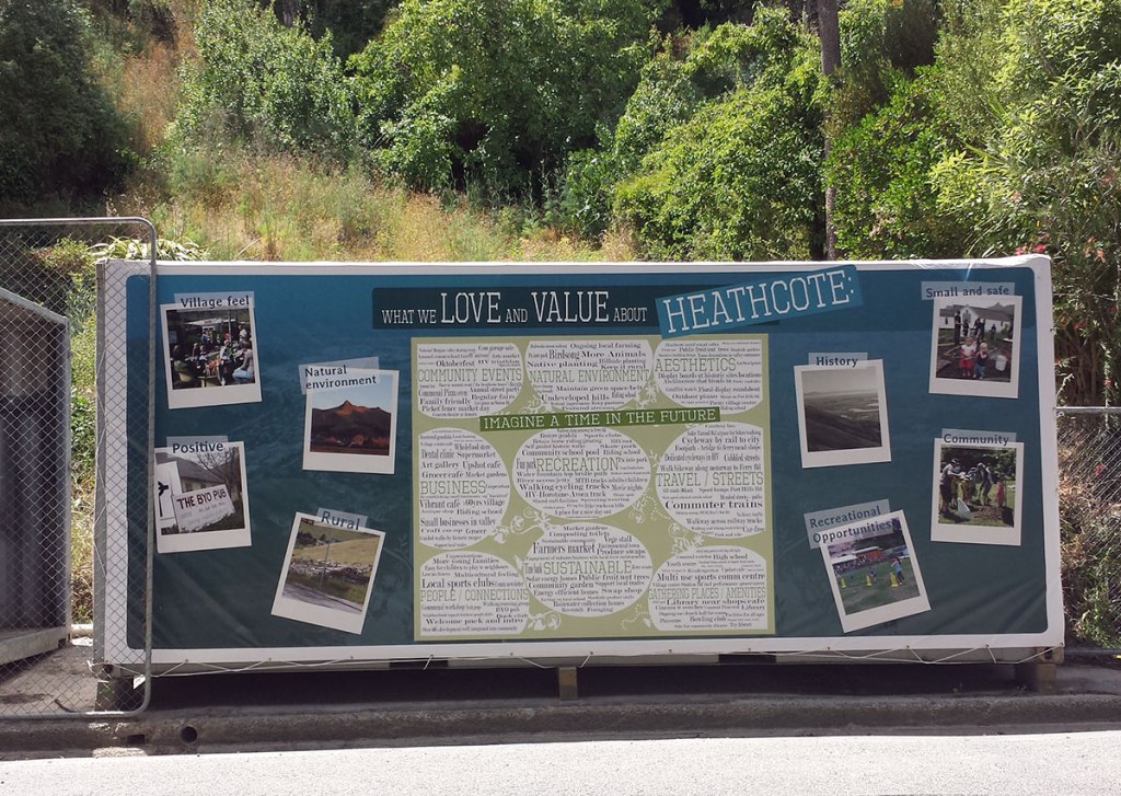 A decorated shipping container displaying the message 'What we love and value about Heathcote', featuring images and text related to community, environment, and local history, located on Bridle Path Road.