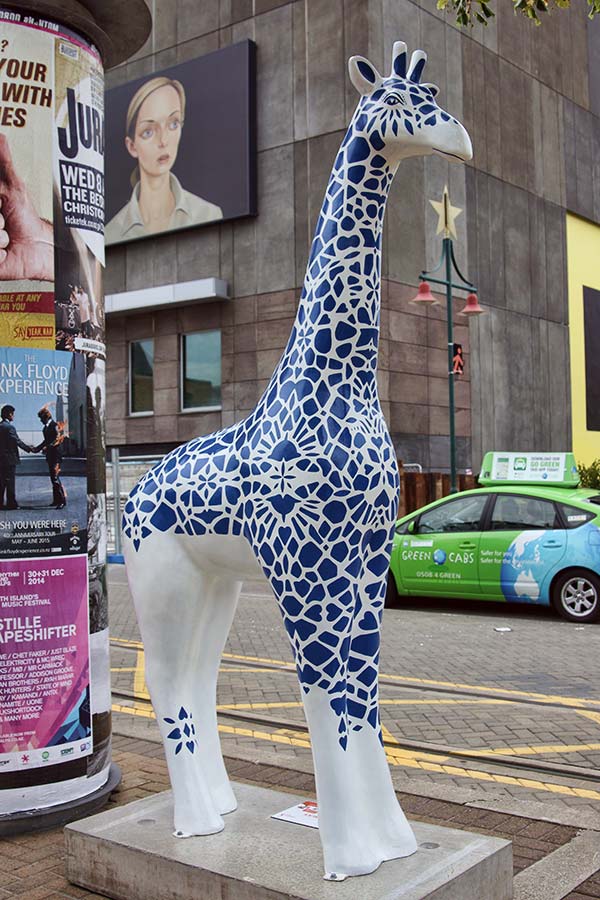 A decorative giraffe sculpture designed by Jeremy Sauzier, featuring blue patterns, located on Worcester Boulevard opposite the Art Gallery.